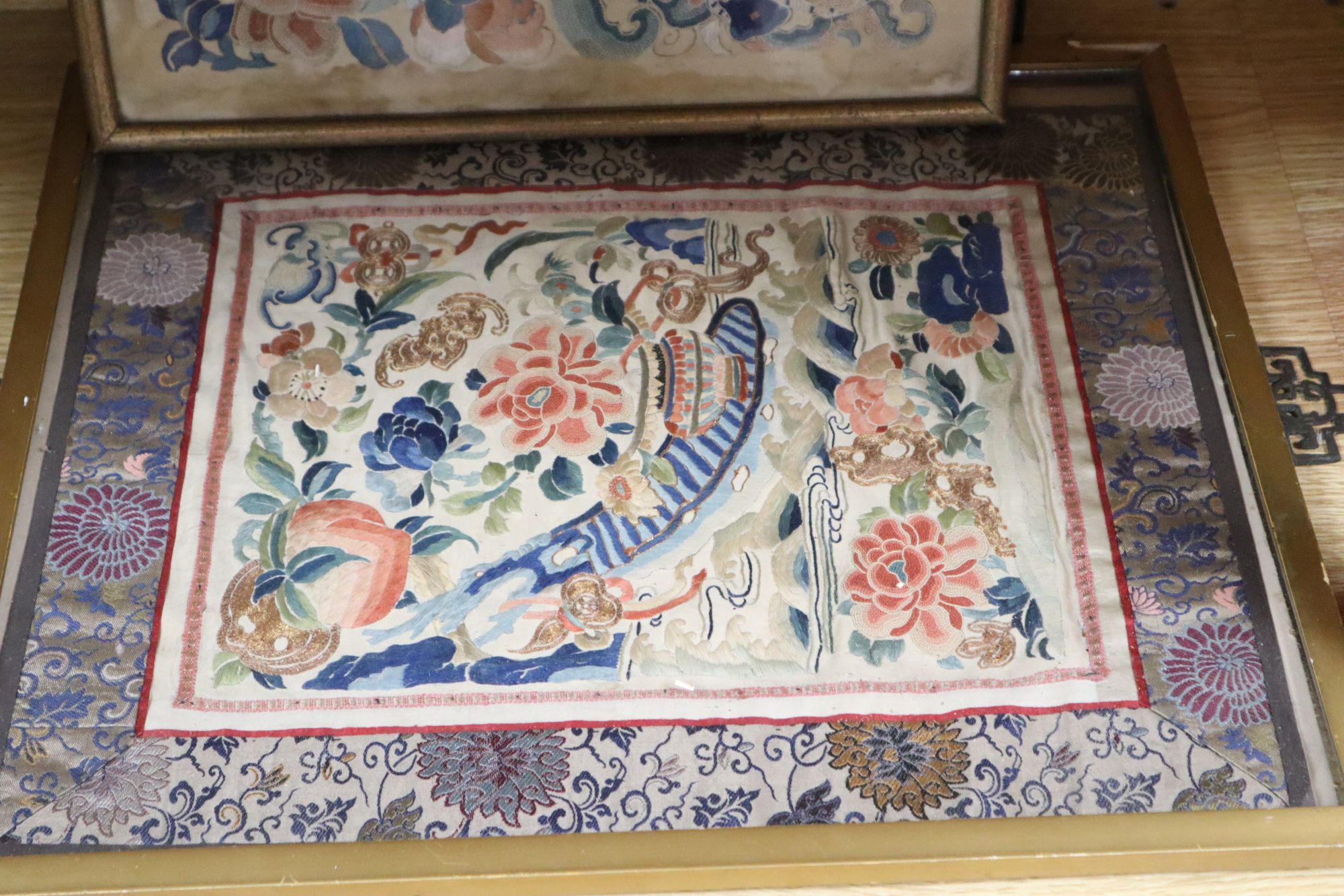 Three Chinese embroidered silk floral panels and a similar woven with objects, 19th century